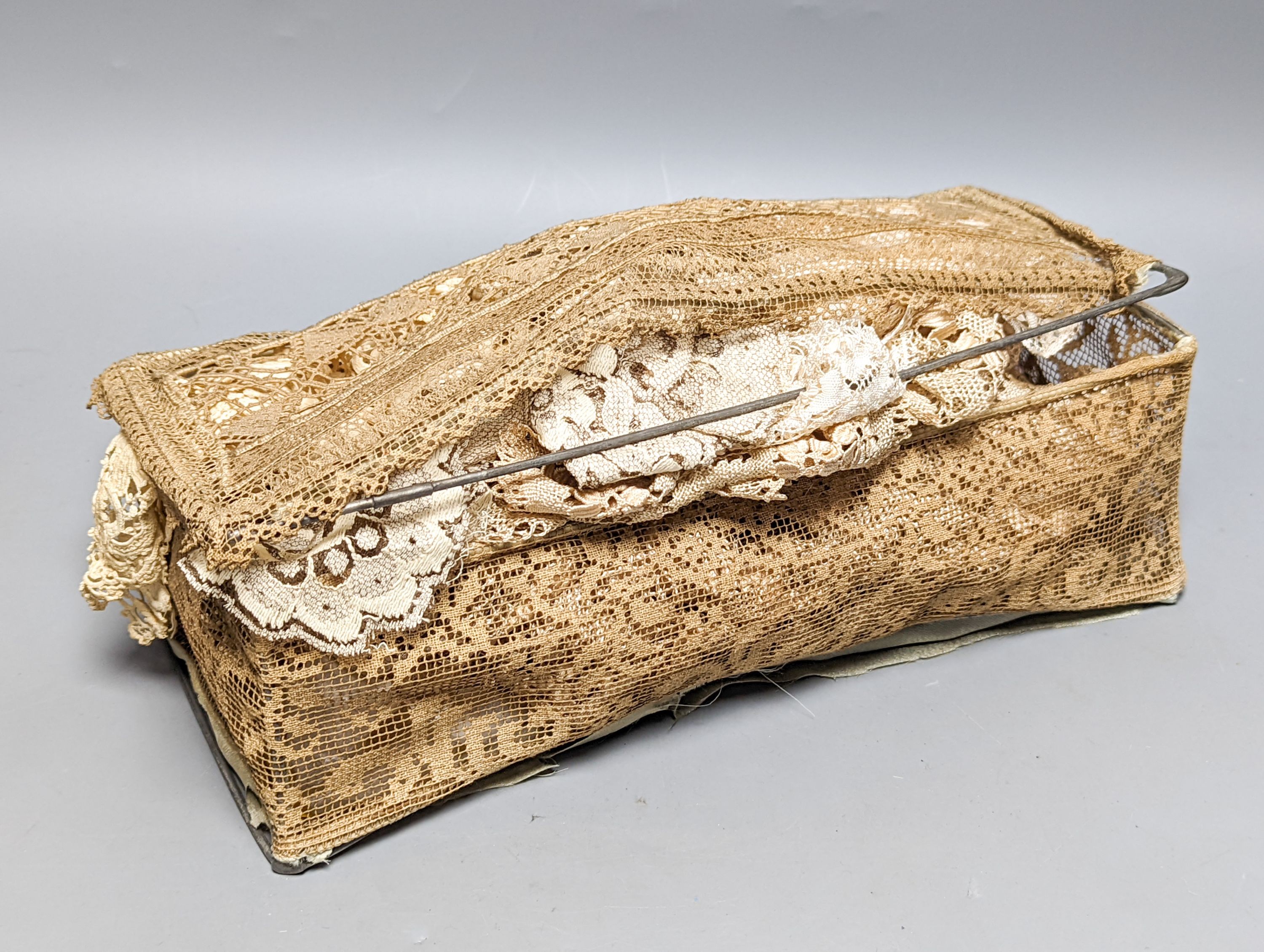 A filet lace box containing a silk Maltese hand bobbin lace veil and stole and an Irish crochet collar and machine net veil